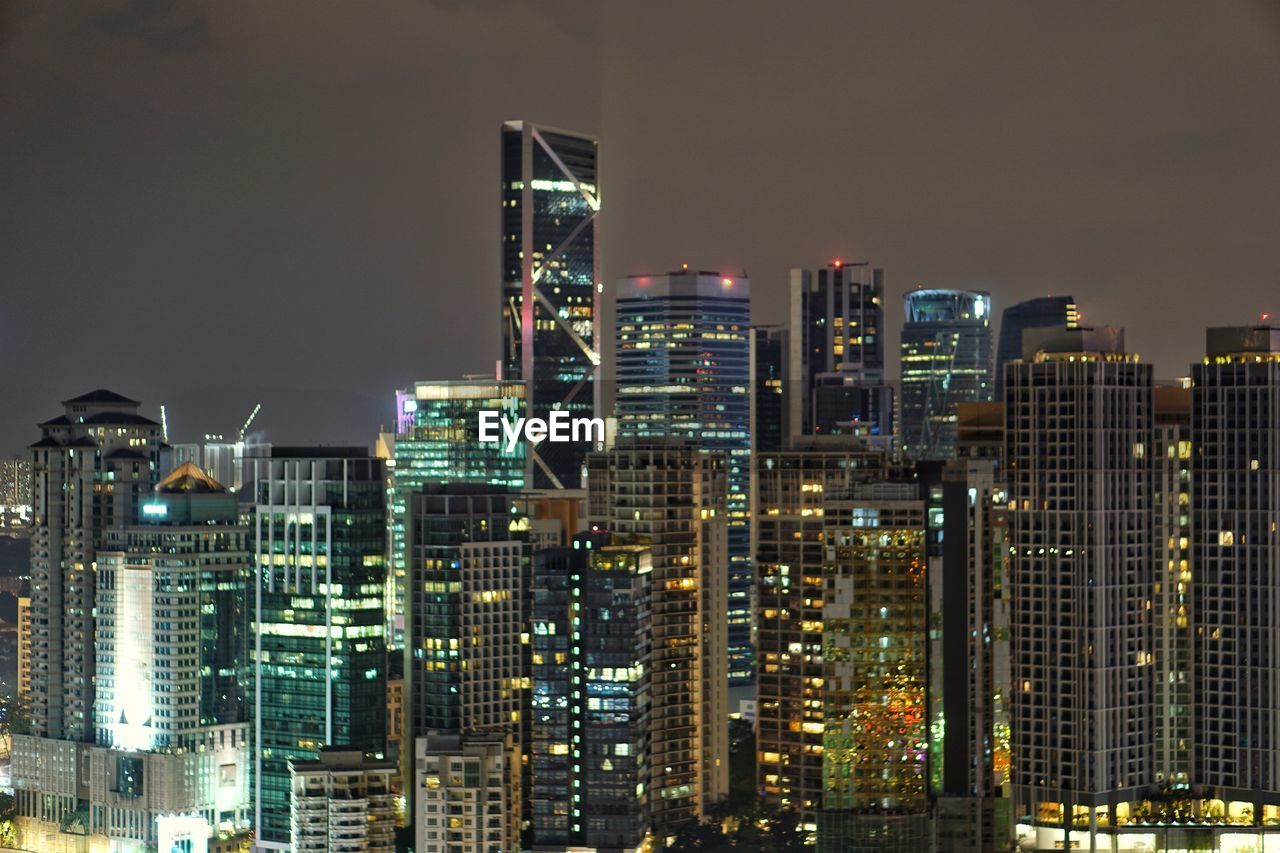 VIEW OF SKYSCRAPERS AT NIGHT