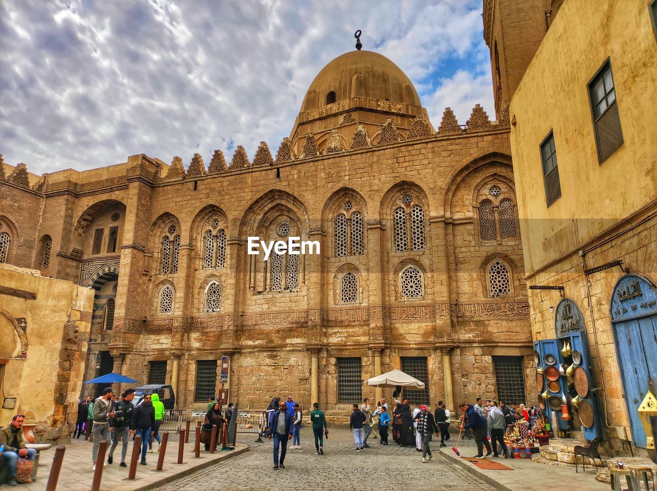 architecture, built structure, building exterior, travel destinations, group of people, tourism, travel, crowd, large group of people, building, religion, history, the past, sky, city, ancient history, place of worship, arch, belief, landmark, tourist, men, nature, spirituality, women, adult, worship, holiday, lifestyles, trip, vacation, cloud, leisure activity, outdoors, facade, day, ancient, historic site, dome