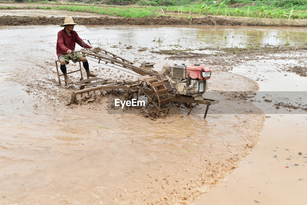 Man working with equipment in agricultural field