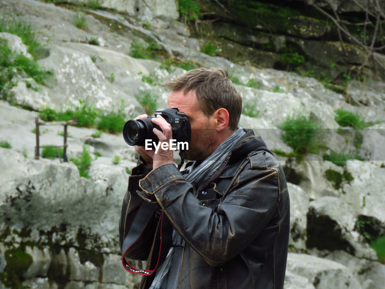 Man photographing while standing outdoors