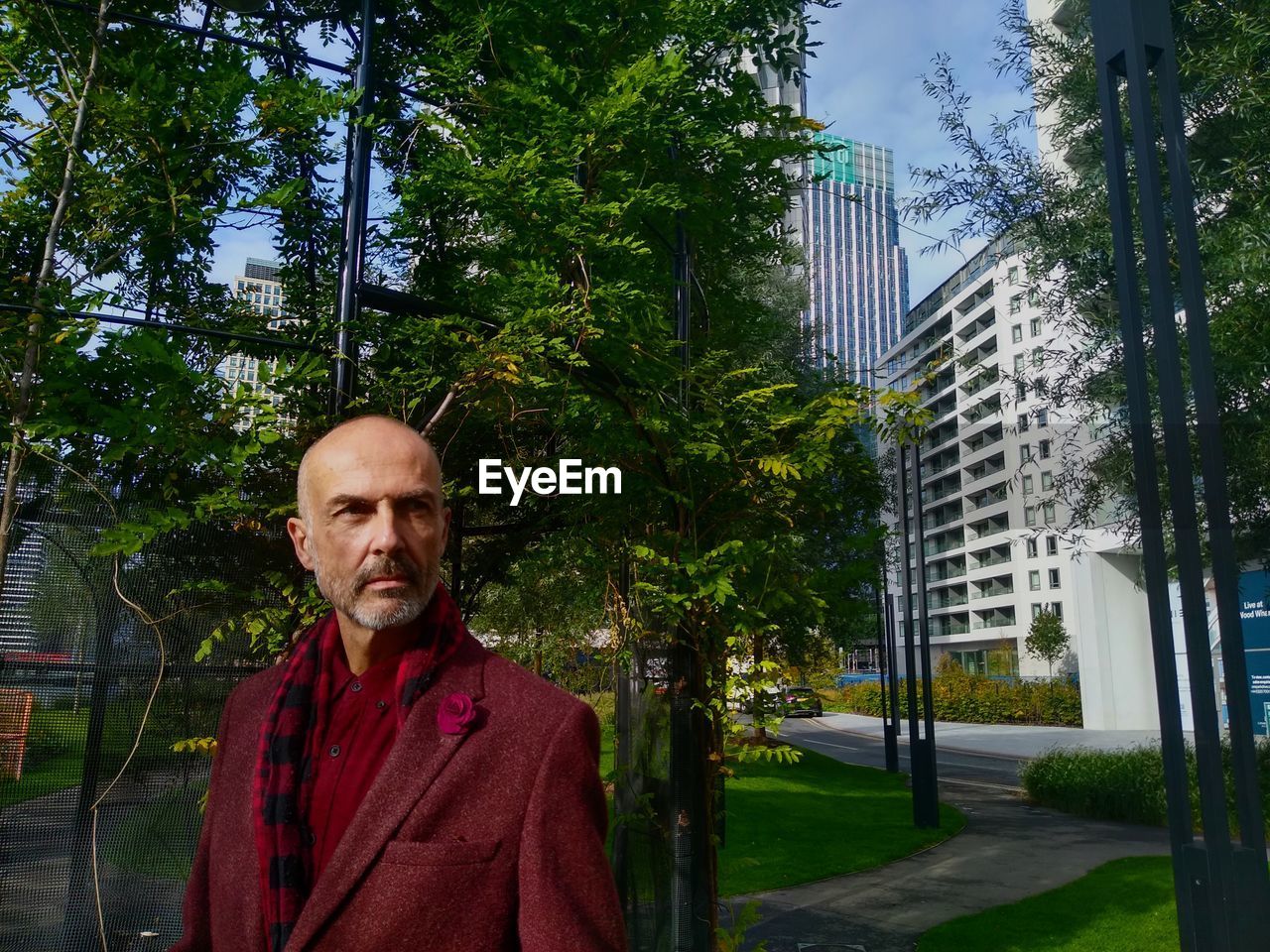 Portrait of young man standing in city