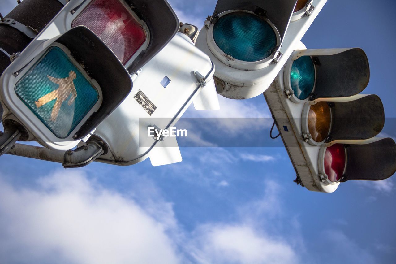 Low angle view of traffic signal against sky