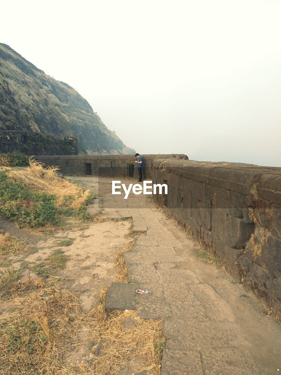 ROAD BY CLIFF AGAINST SKY