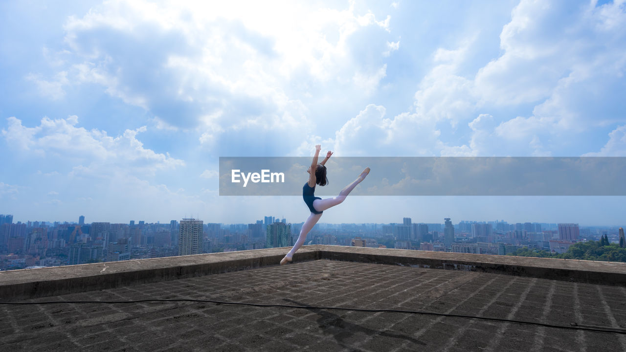 Ballerina dancing on building terrace