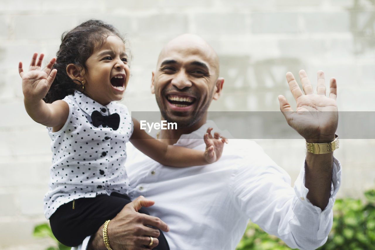 PORTRAIT OF FATHER AND SON OUTDOORS