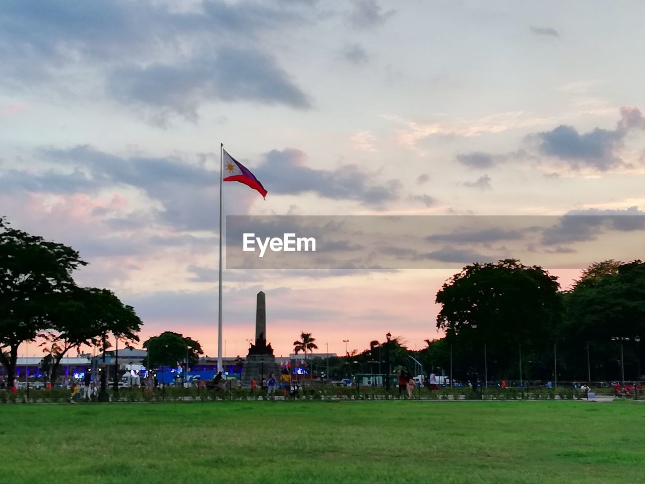 FLAG AGAINST SKY AT SUNSET