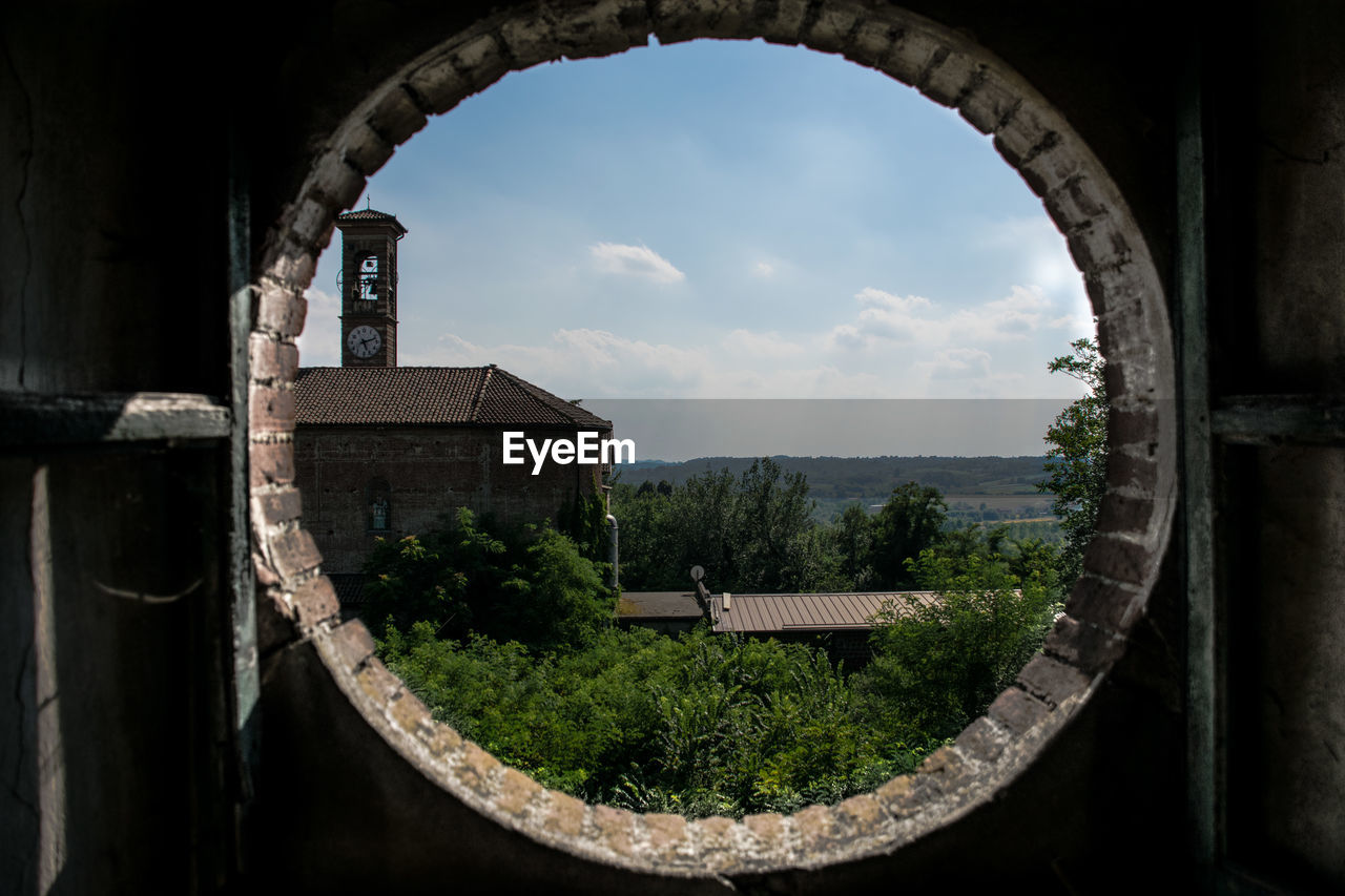 House and trees seen through window