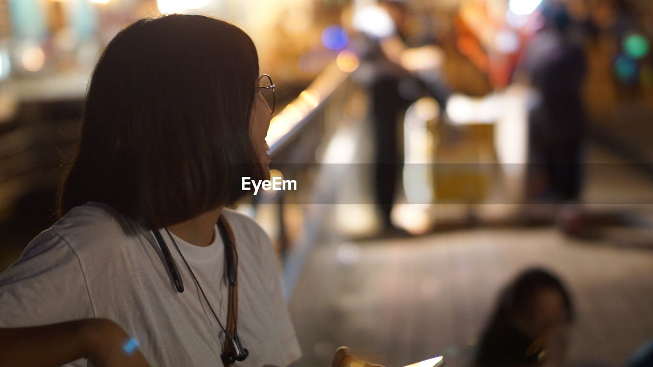 Midsection of asian woman looking away