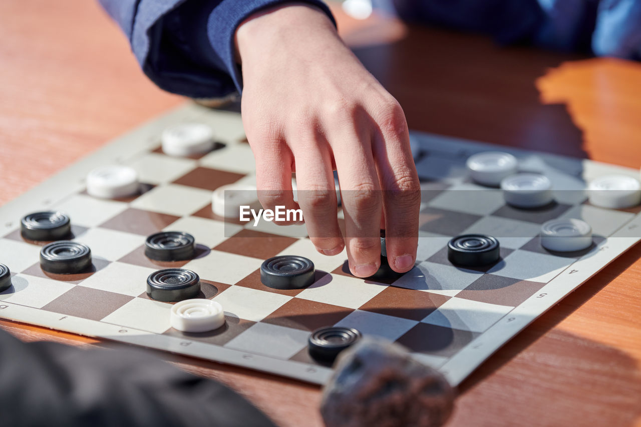 midsection of man playing sound mixer at table