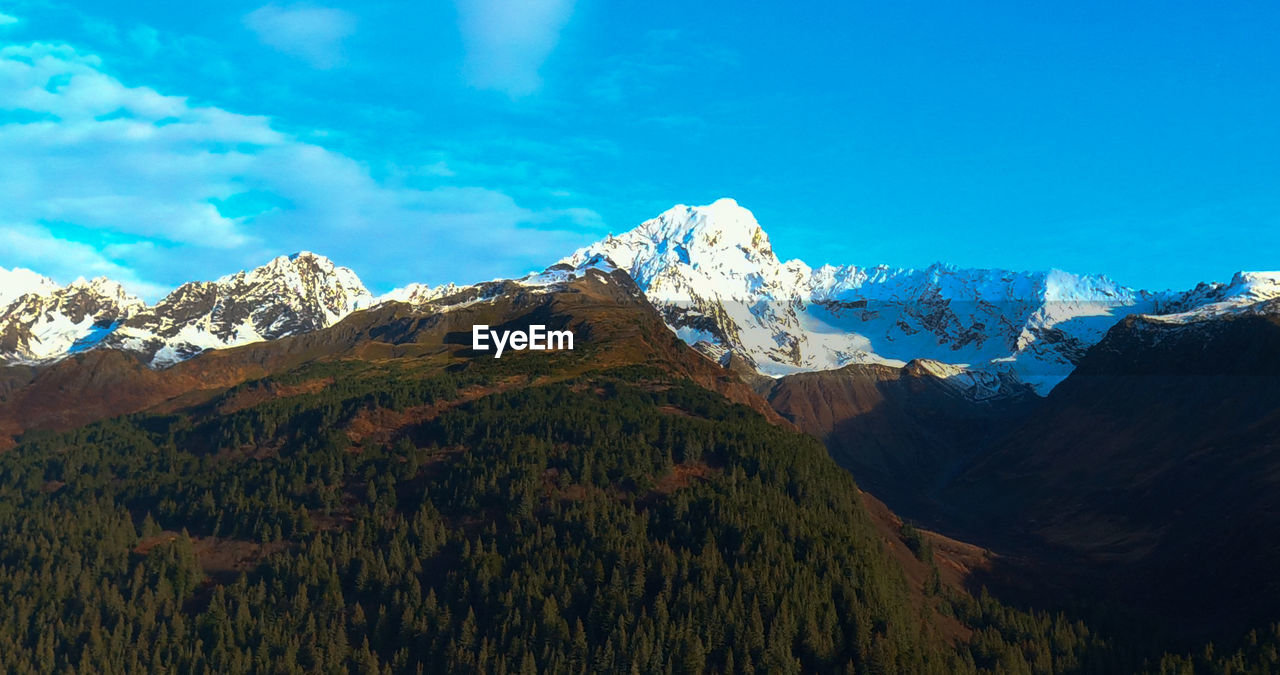 Scenic view of snowcapped mountains against sky