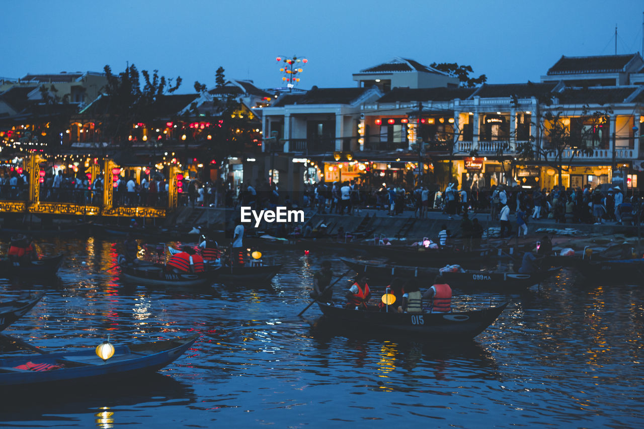 BOATS IN CANAL BY ILLUMINATED BUILDING