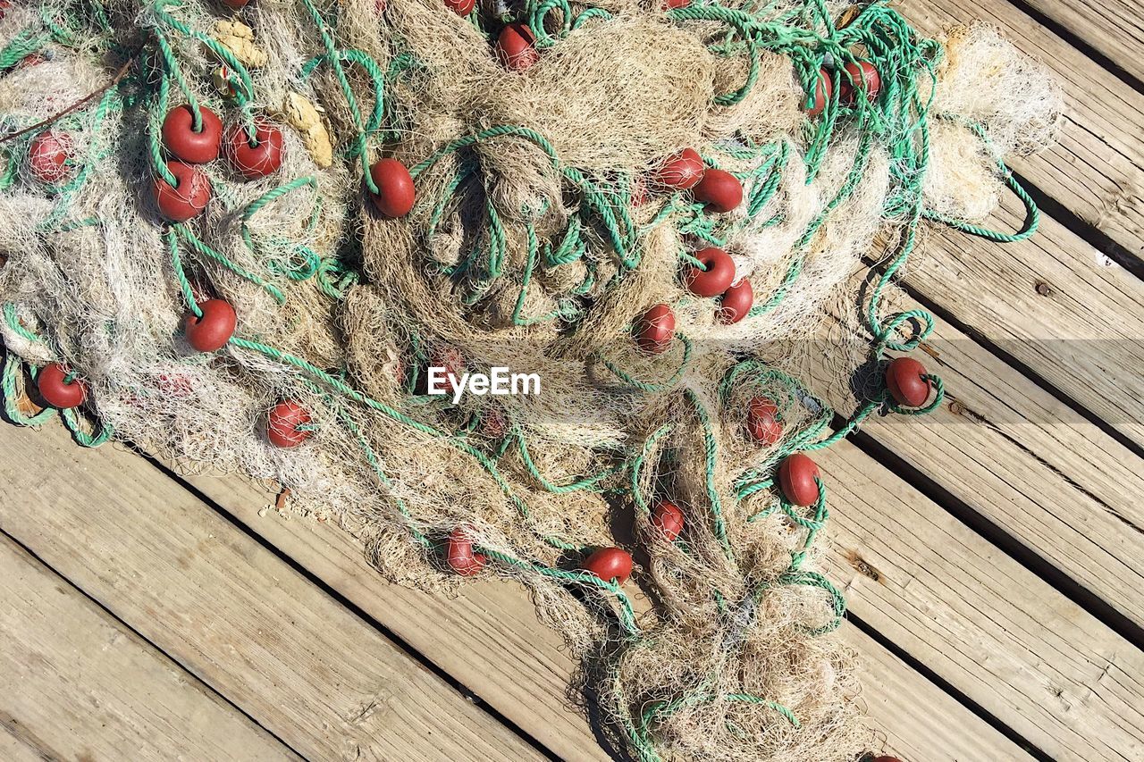 High angle view of fishing net on hardwood floor