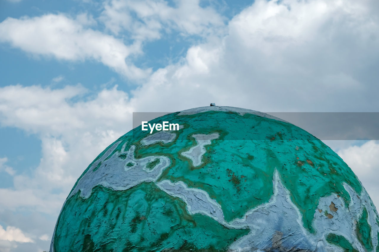 Metal globe shaped world against sky in turkey