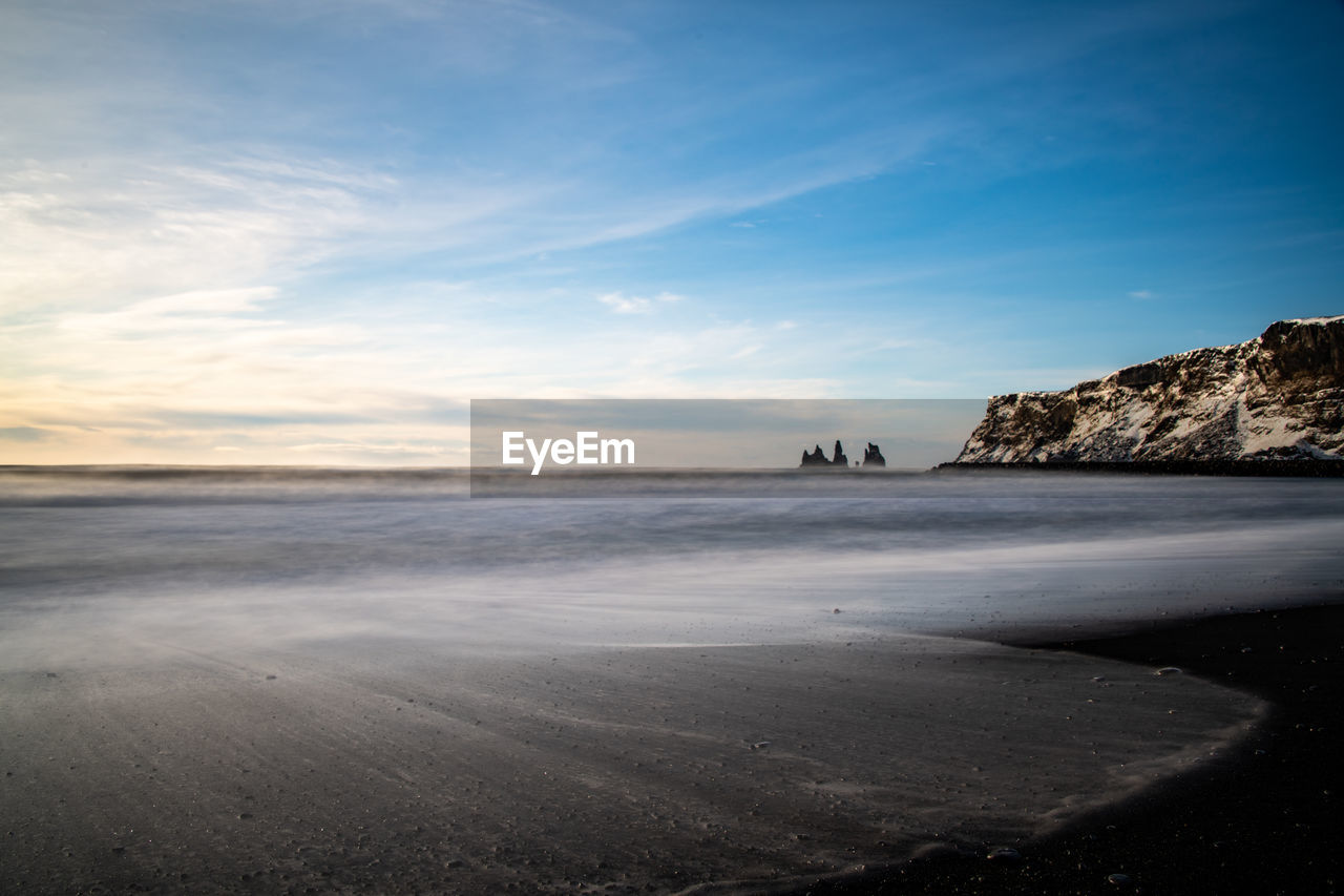 Scenic view of beach against sky during sunset