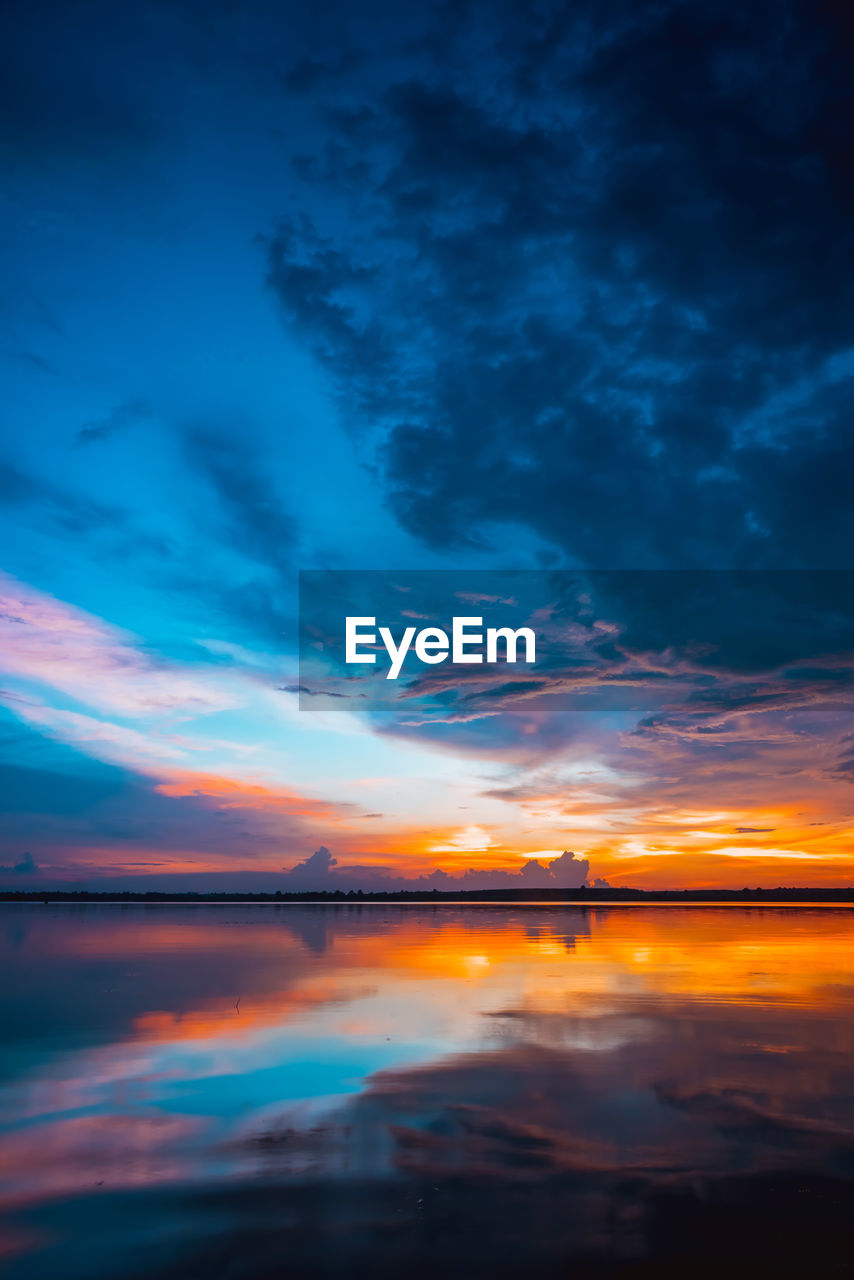 Scenic view of dramatic sky over sea during sunset