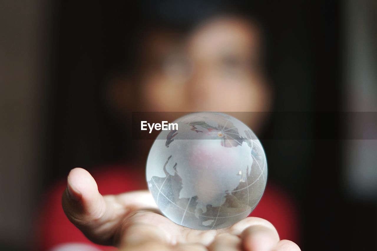 Woman holding crystal globe