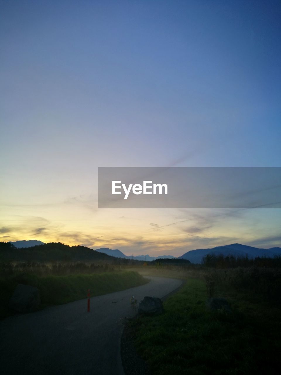 SCENIC VIEW OF ROAD AGAINST SKY DURING SUNSET