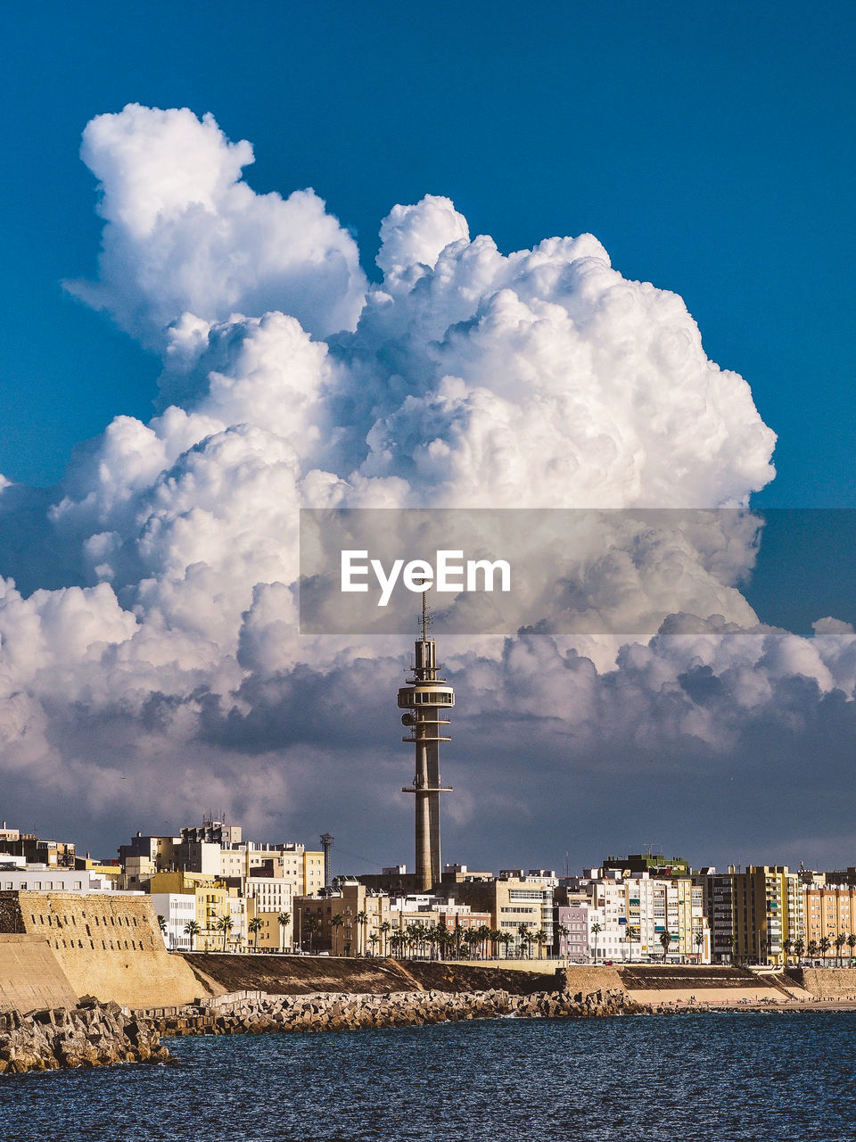 COMMUNICATIONS TOWER BY SEA AGAINST SKY