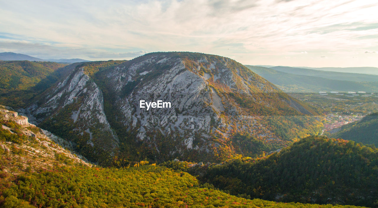 Scenic view of mountain against cloudy sky