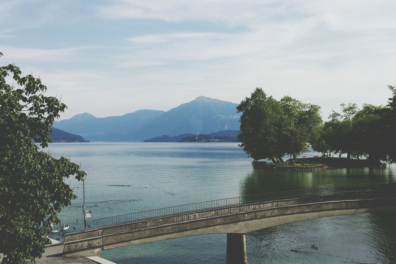 Calm lake against mountain range