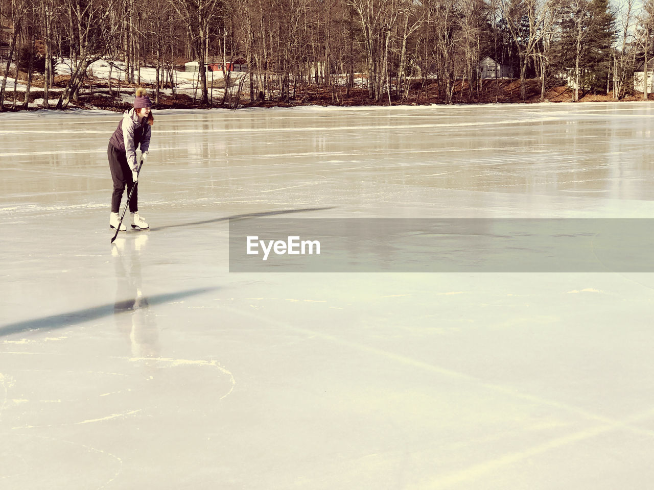 Pre-adolescent girl playing ice hockey