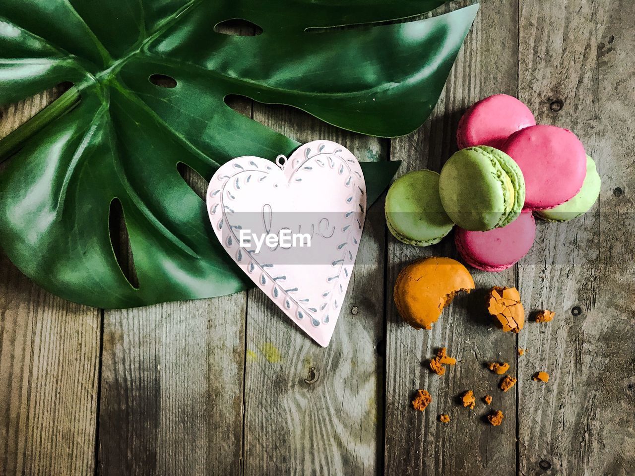High angle view of macaroons with text on heart shape at table