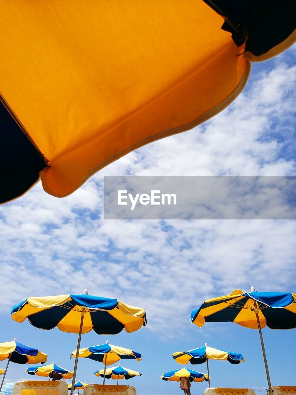 Low angle view of parasol against sky