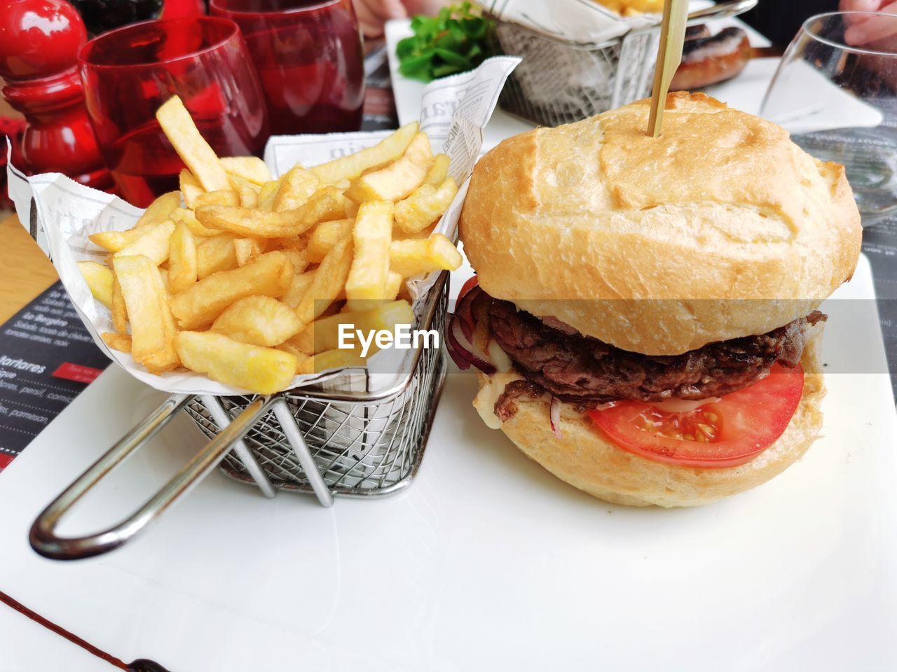 HIGH ANGLE VIEW OF BURGER AND MEAT ON TABLE