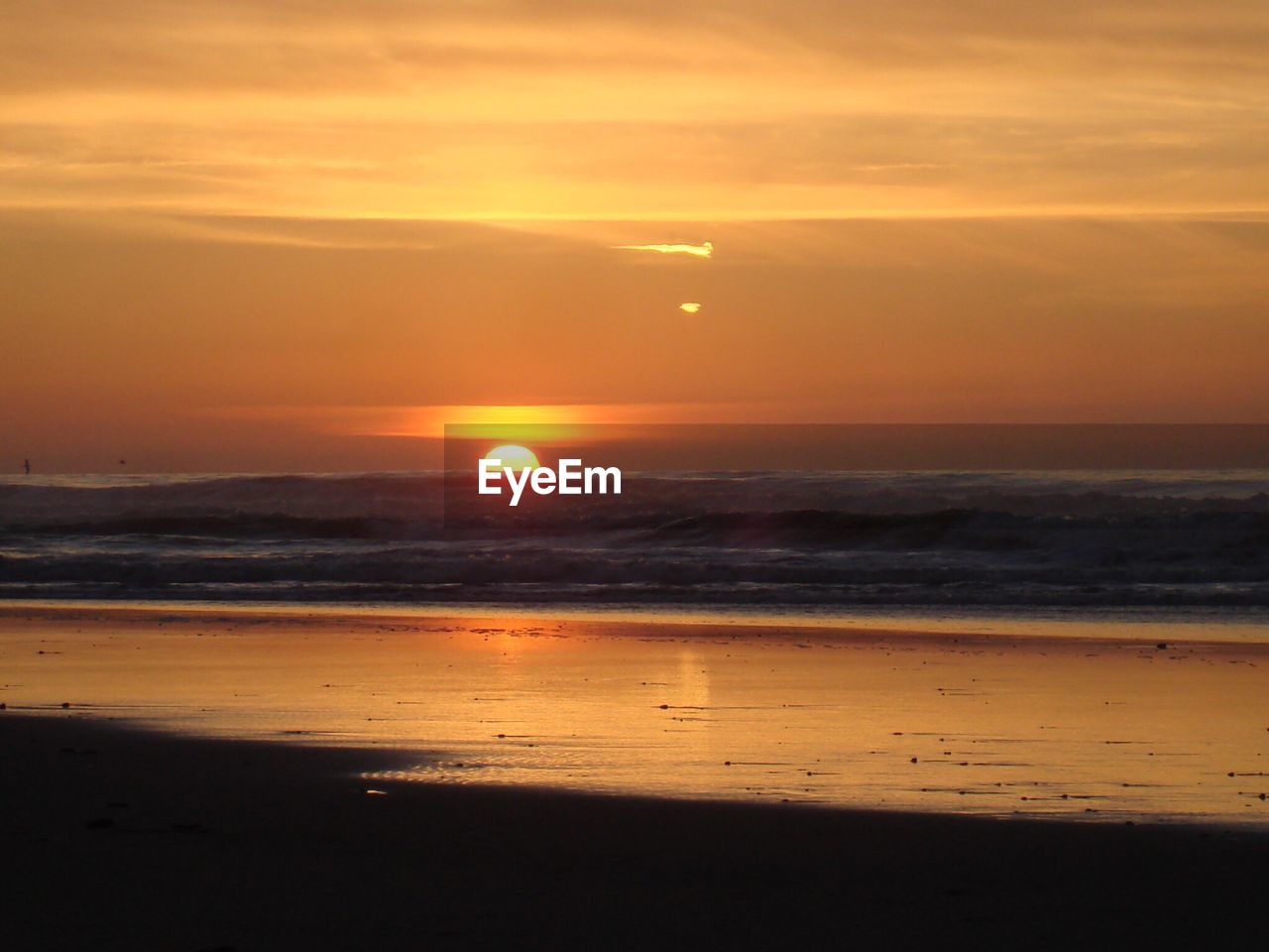 SCENIC VIEW OF BEACH DURING SUNSET