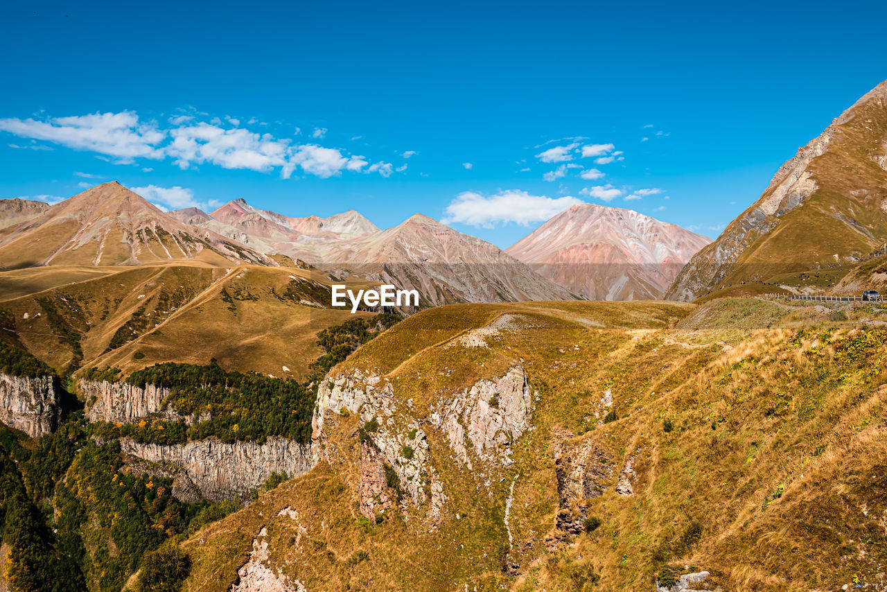 Scenic view of mountains against clear blue sky
