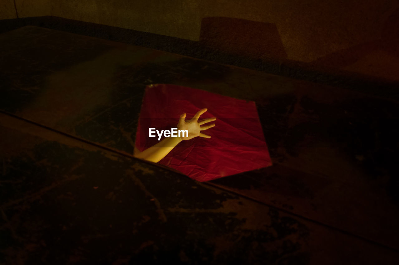 HIGH ANGLE VIEW OF RED PAPER ON FLOOR