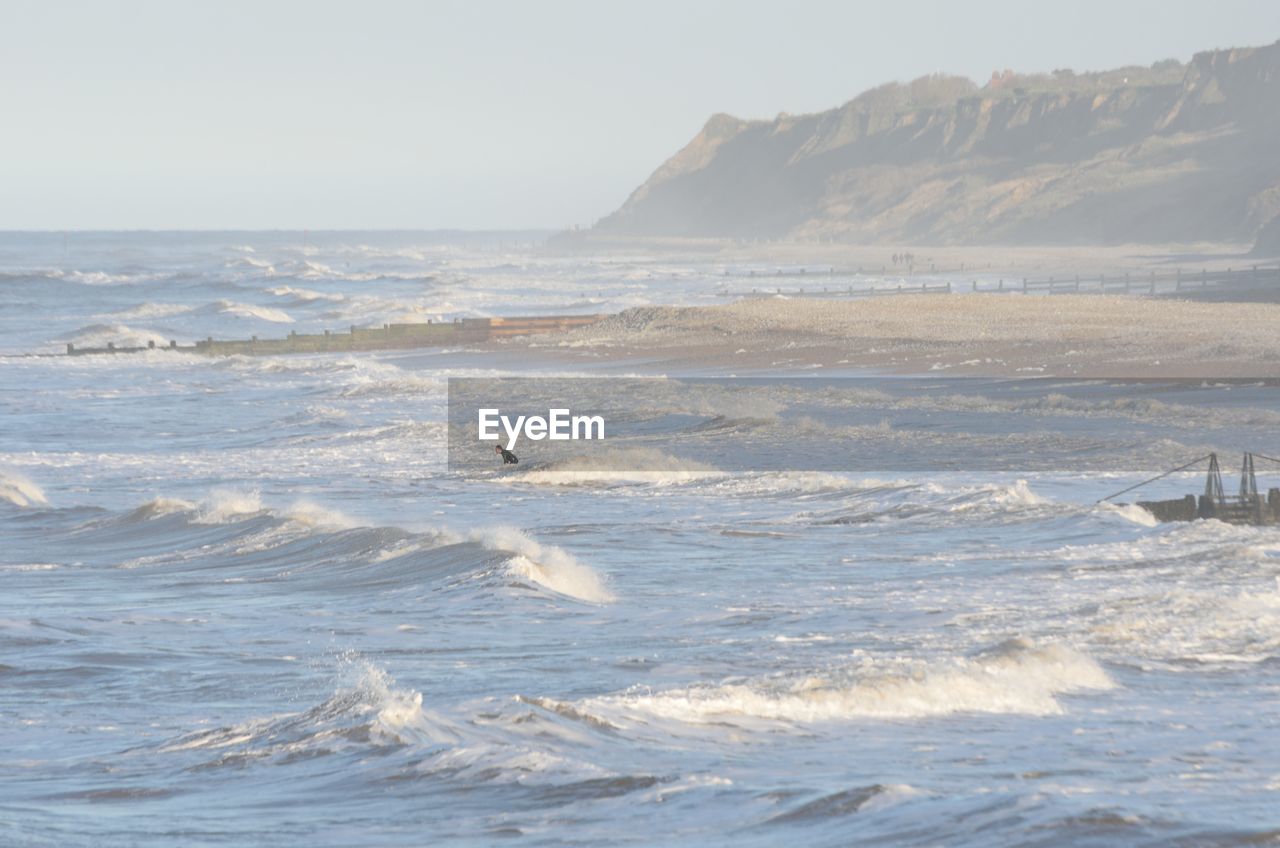 SCENIC VIEW OF SEA WAVES AGAINST SKY