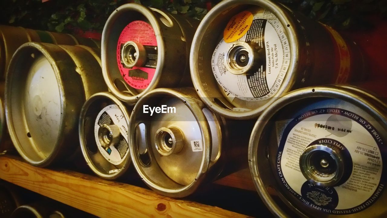 Close-up of beer kegs in shelf