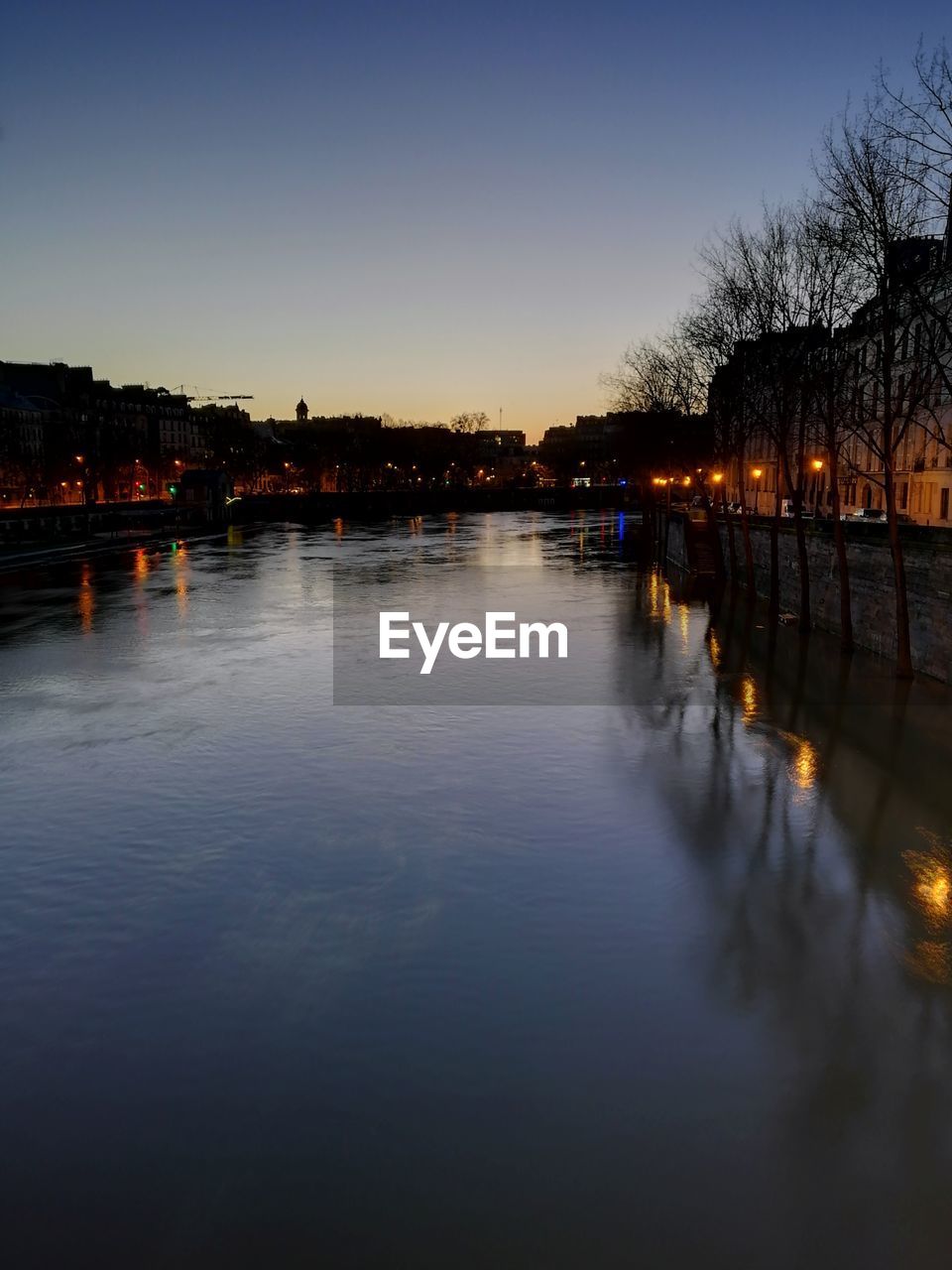 SCENIC VIEW OF RIVER AGAINST CLEAR SKY DURING SUNSET