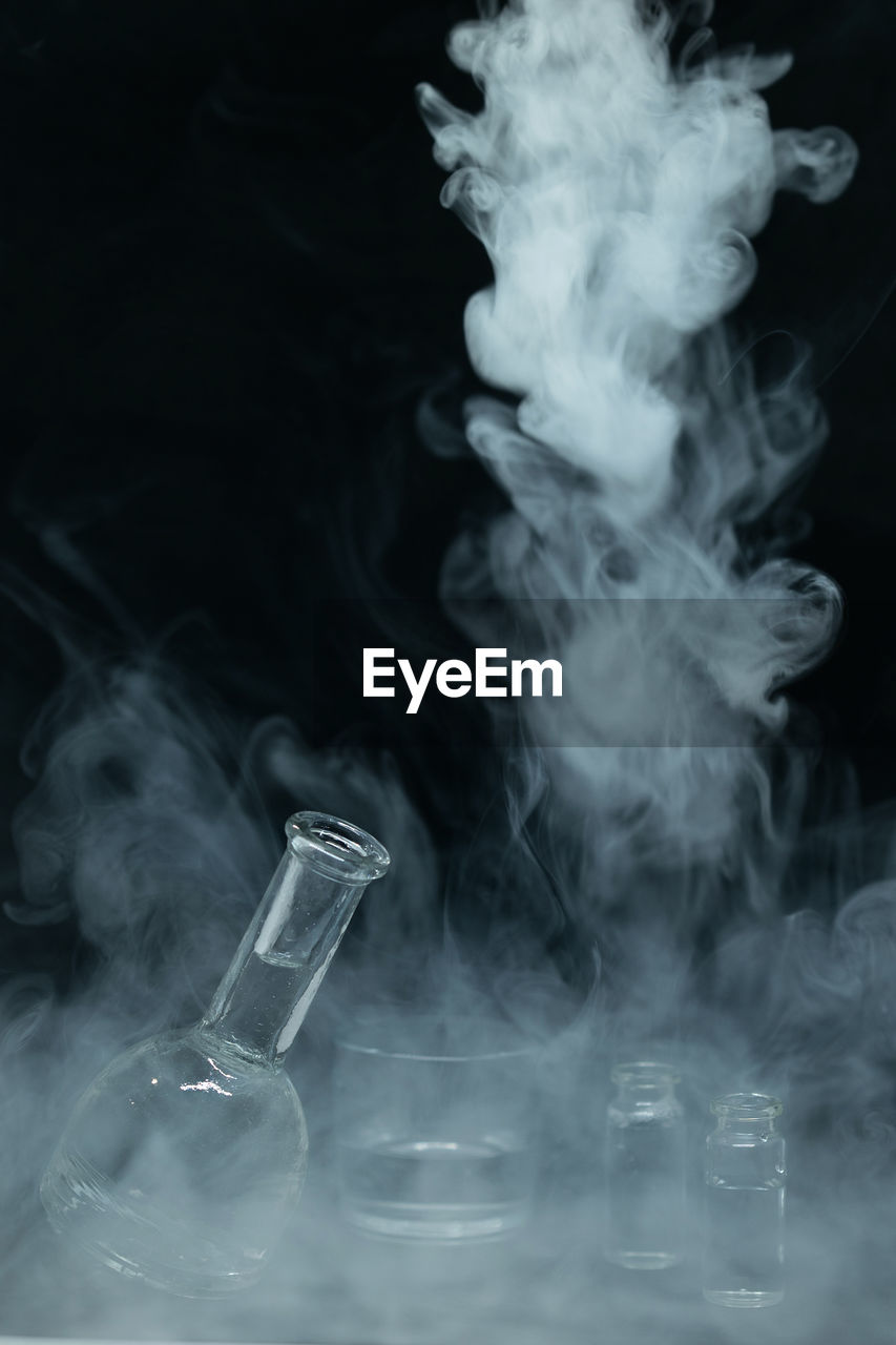 CLOSE-UP OF SMOKE EMITTING FROM GLASS OF BLACK