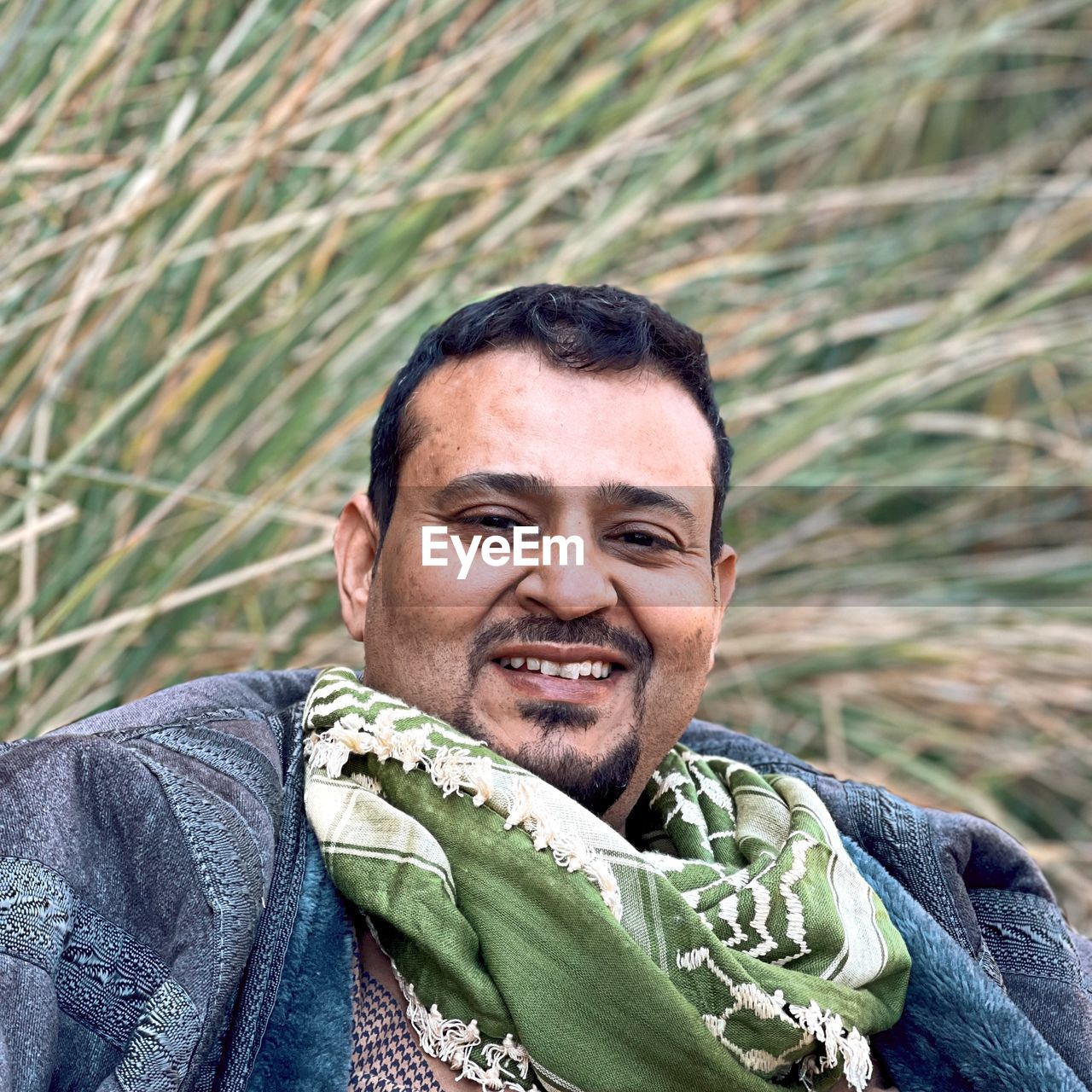 portrait, adult, smiling, men, one person, happiness, person, emotion, looking at camera, headshot, nature, cheerful, clothing, plant, lifestyles, human face, rural scene, front view, outdoors, landscape, mature adult, portrait photography, green, day, casual clothing, smile, copy space, teeth, beard, land, looking, positive emotion