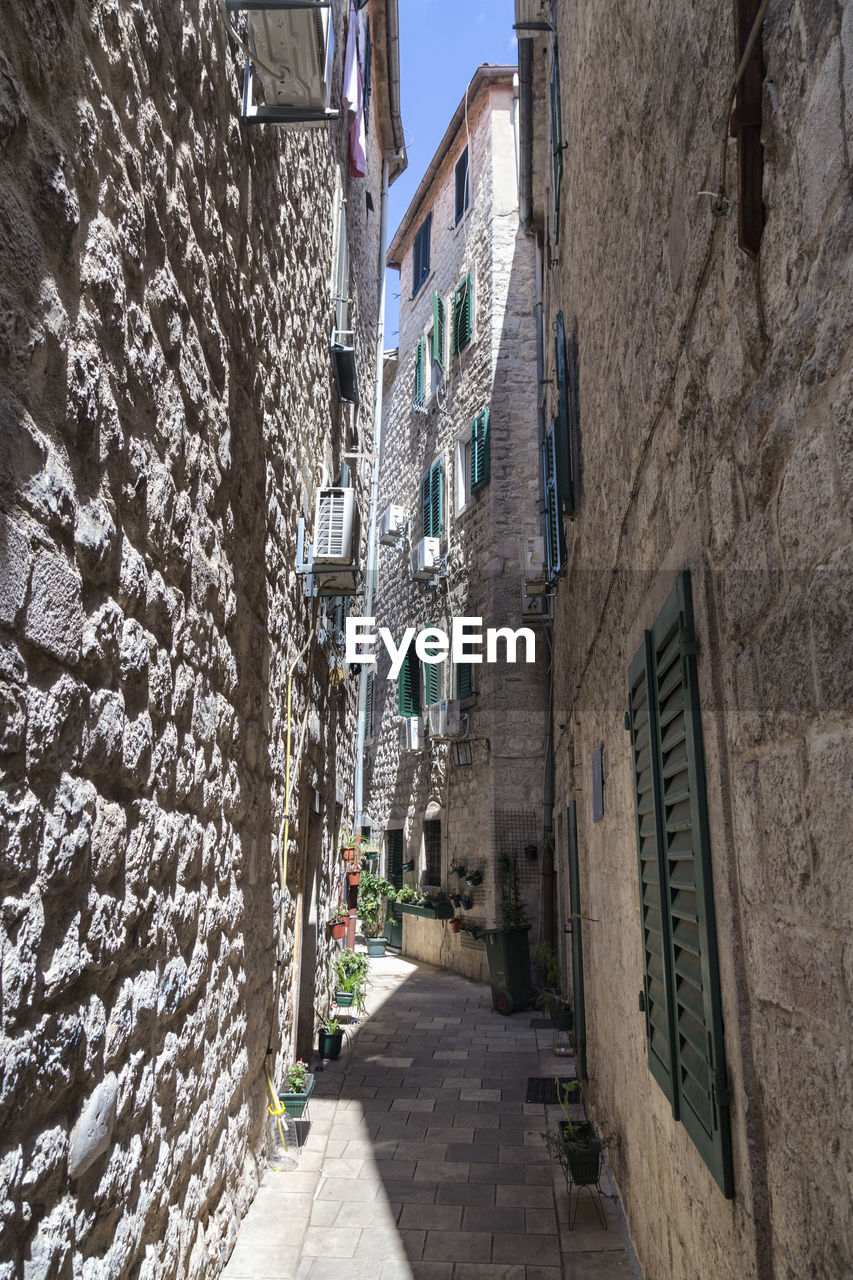 NARROW STREET AMIDST BUILDINGS