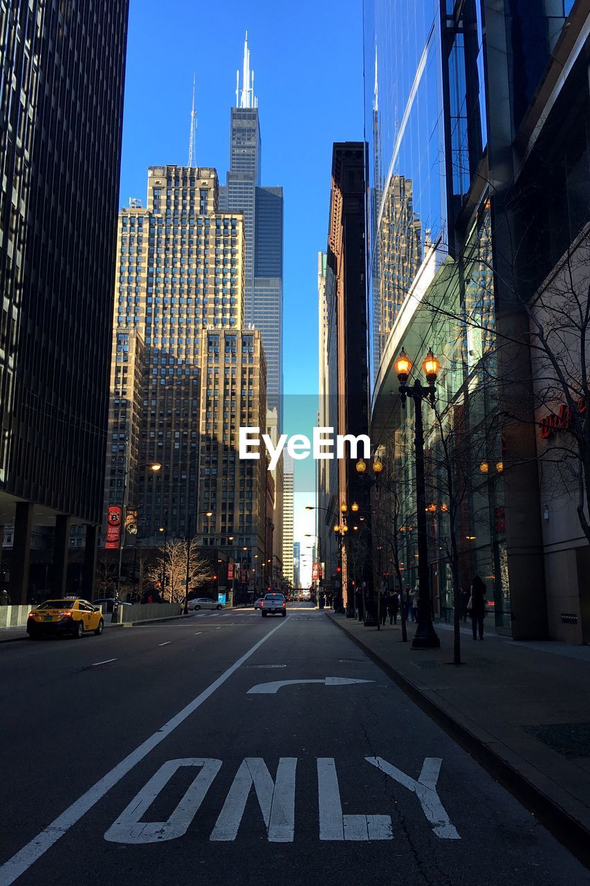 Street amidst modern buildings in city