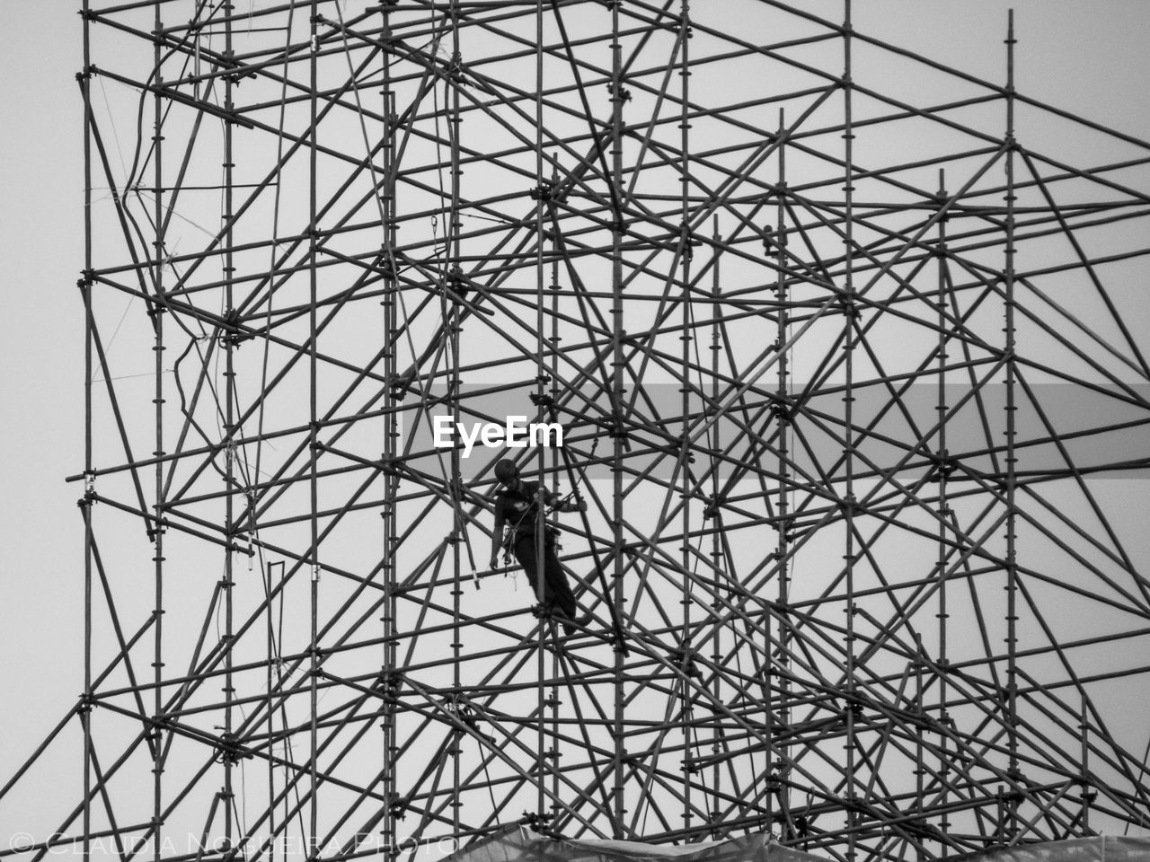 Low angle view of man at construction site against sky