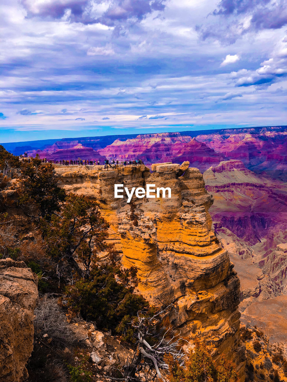 Aerial view of rock formations against cloudy sky