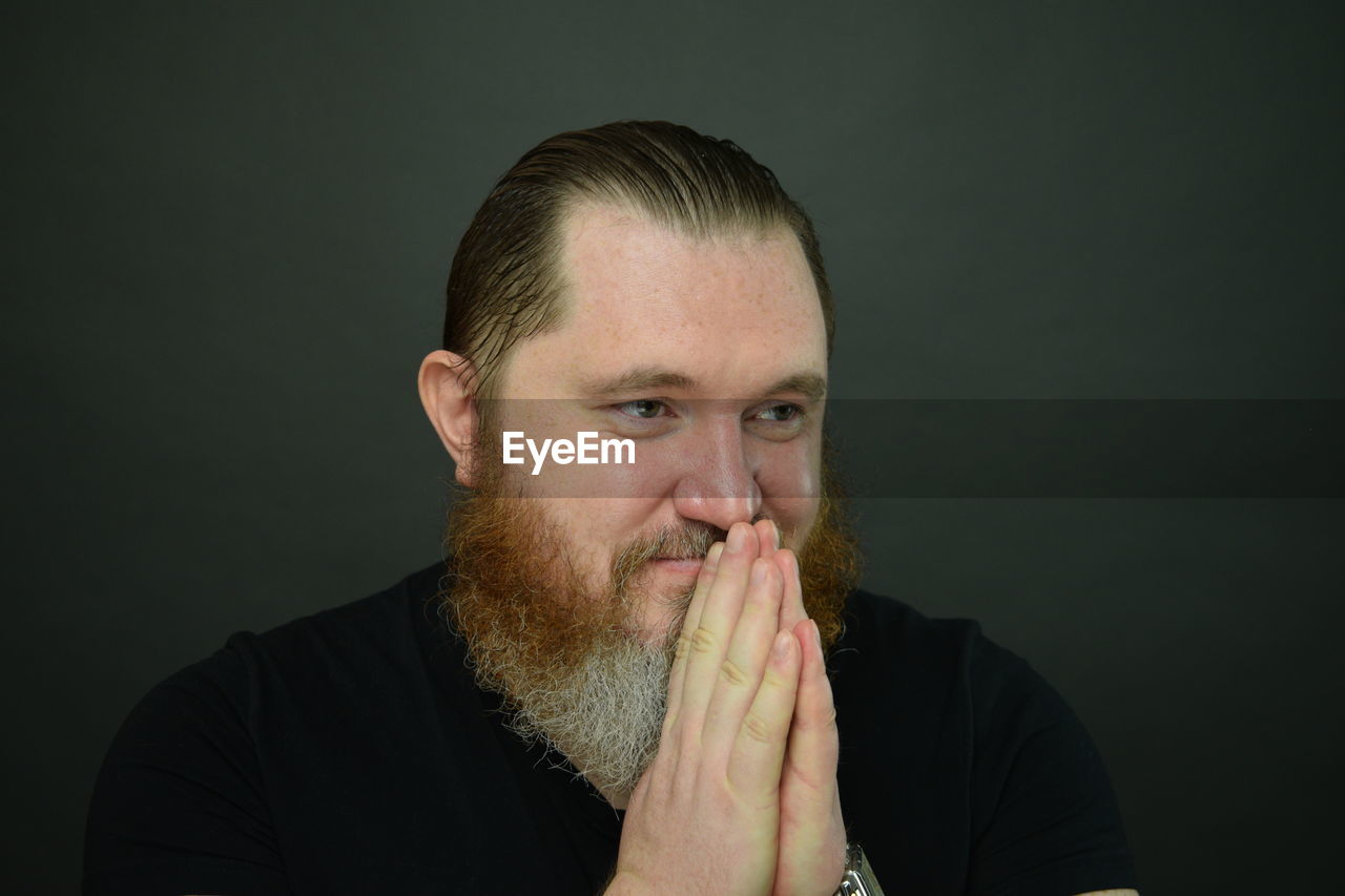 PORTRAIT OF MAN AGAINST WHITE BACKGROUND