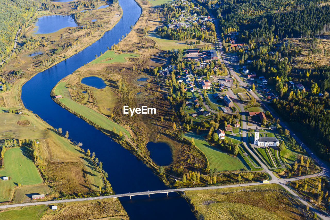 Aerial view of river and village in autumn landscape