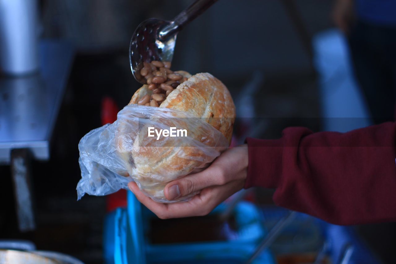 Cropped hand of person holding food