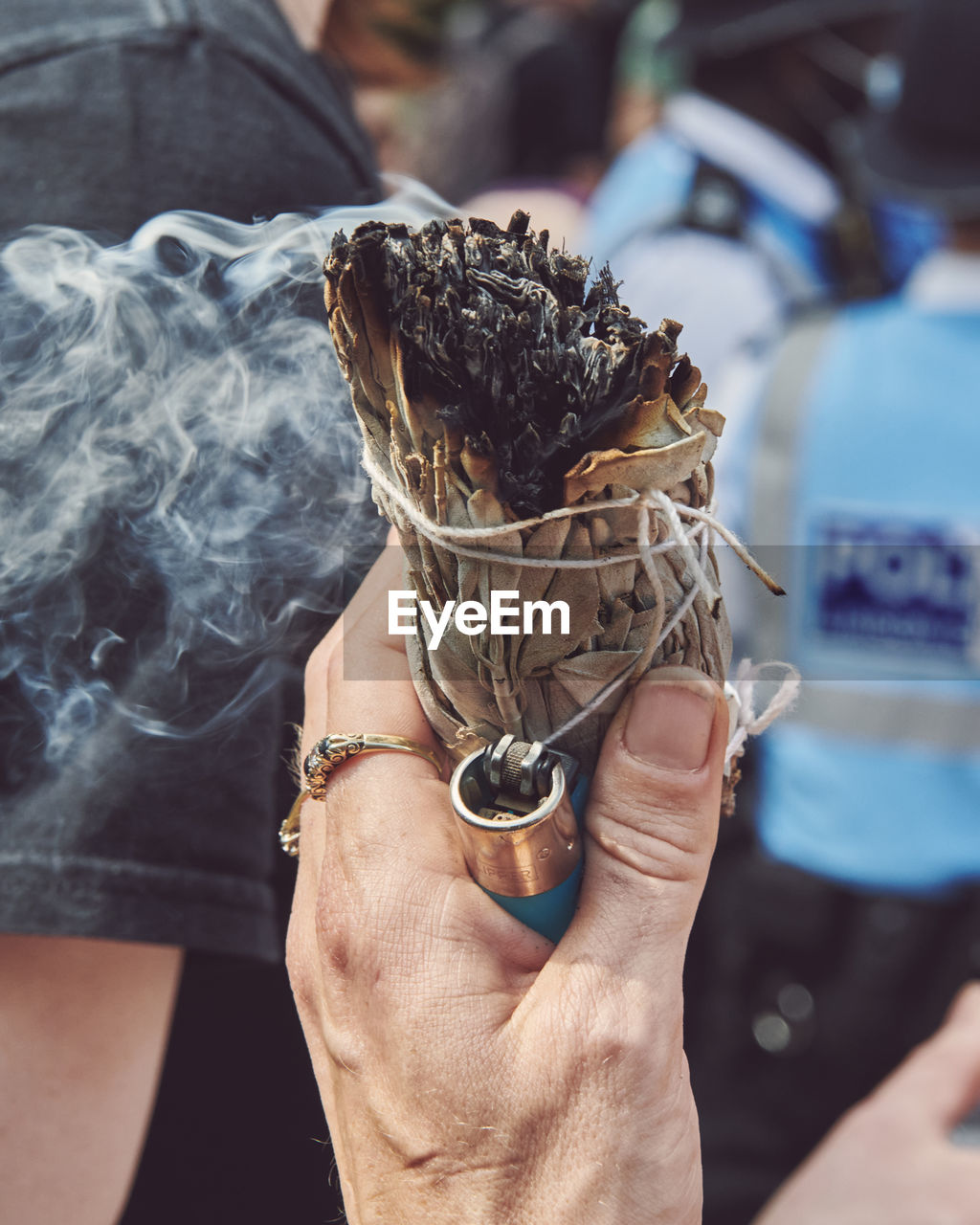 Close-up of a hand holding burning sage