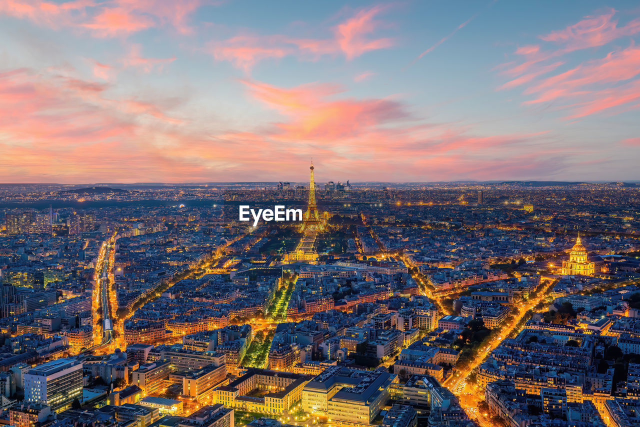 high angle view of illuminated cityscape against sky during sunset