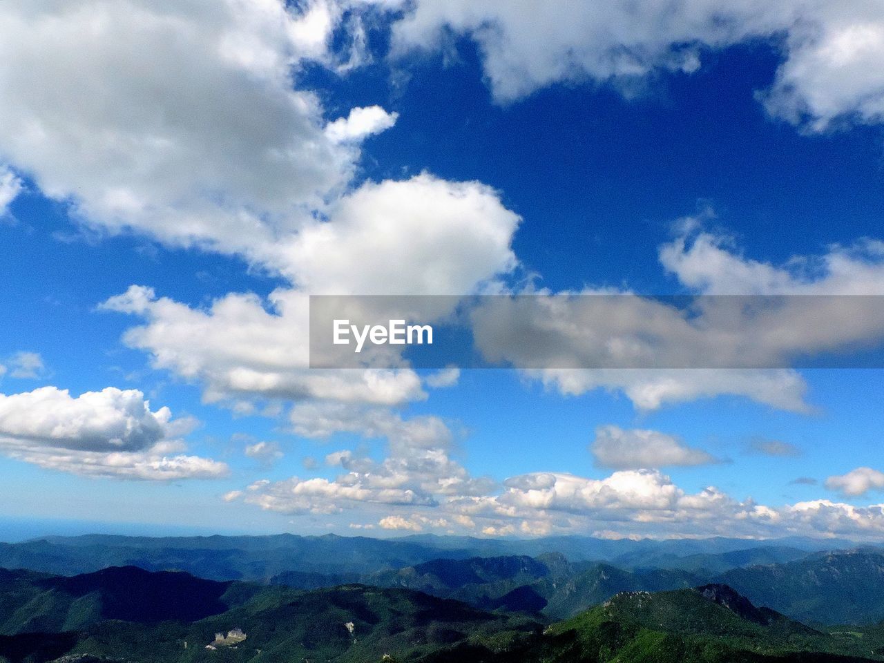 SCENIC VIEW OF CLOUDS OVER LANDSCAPE