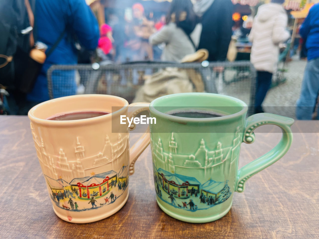 cup, food and drink, drink, mug, coffee cup, hot drink, focus on foreground, refreshment, tea, group of people, adult, table, tableware, tea cup, day, business, coffee, ceramic, food, outdoors, cafe, men