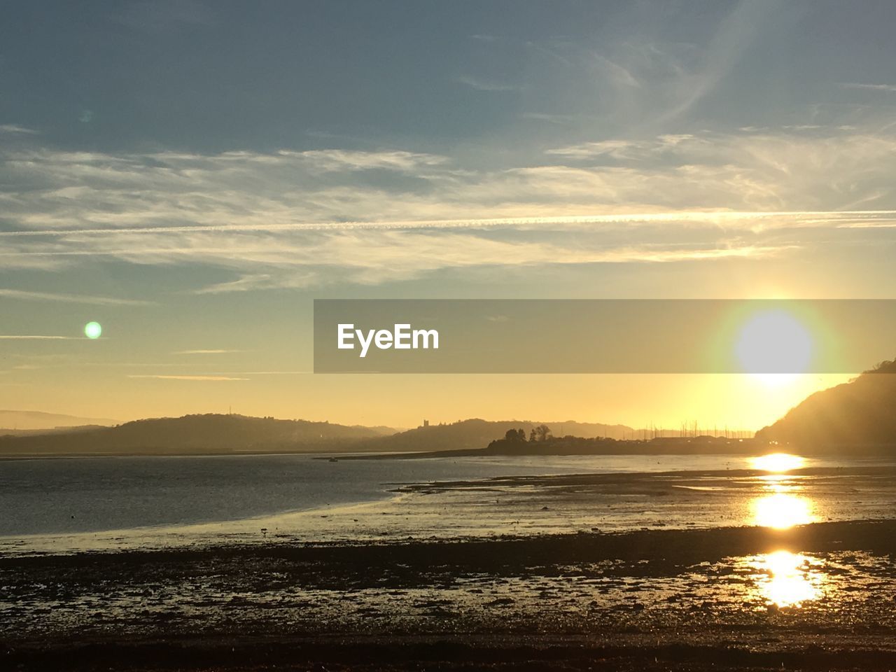 SCENIC VIEW OF BEACH AGAINST SKY DURING SUNSET