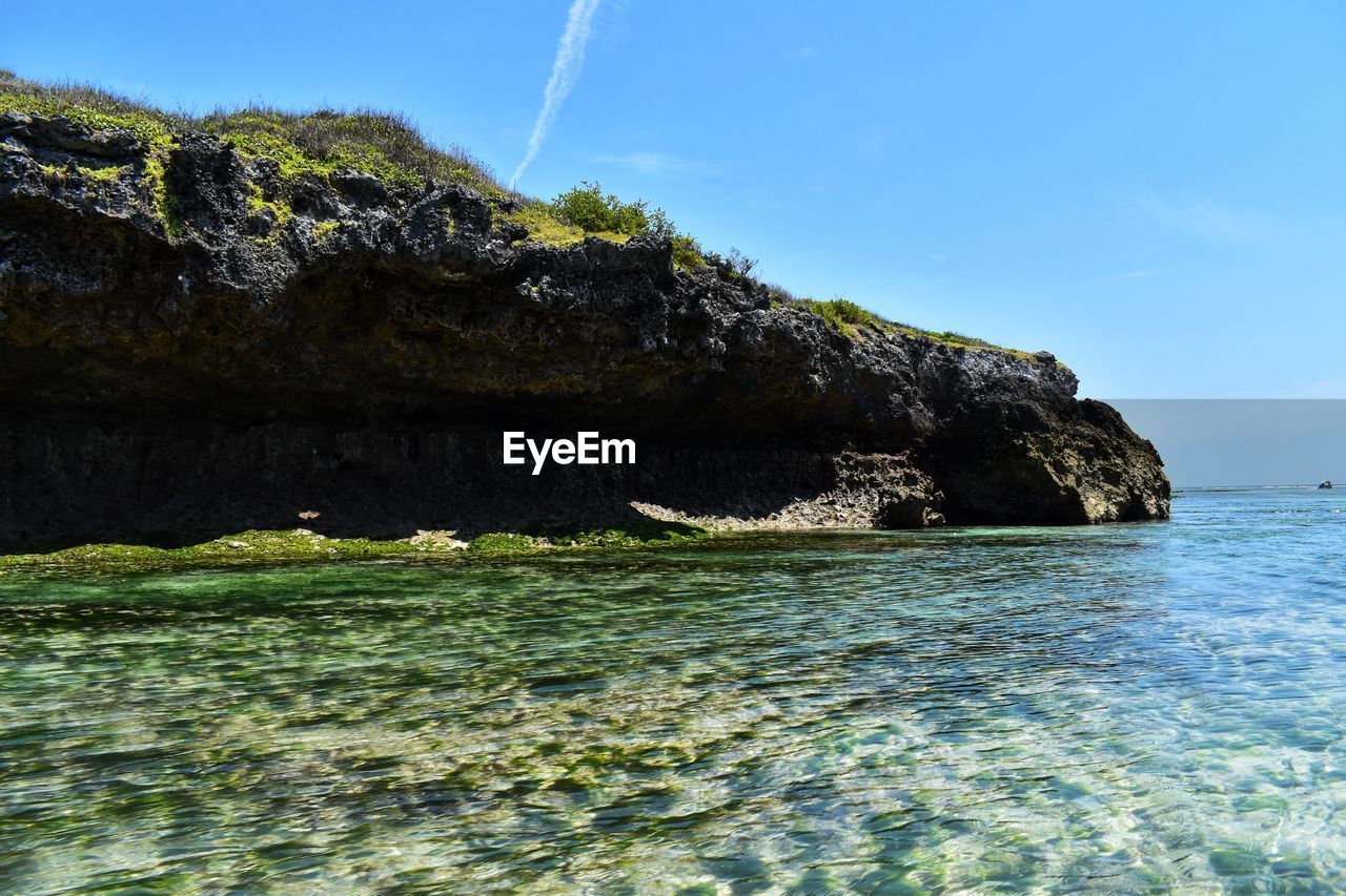 Scenic view of sea against rock formation