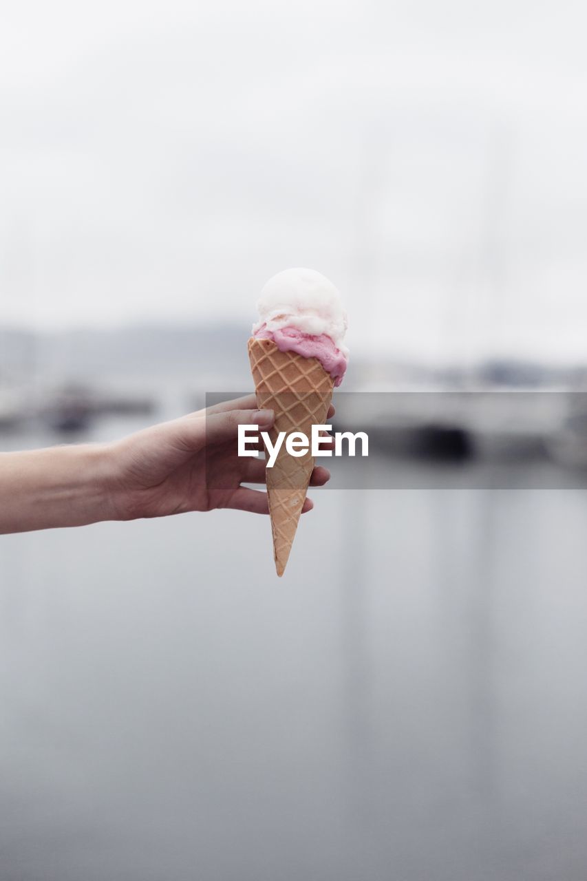 Cropped hand of woman holding ice cream cone